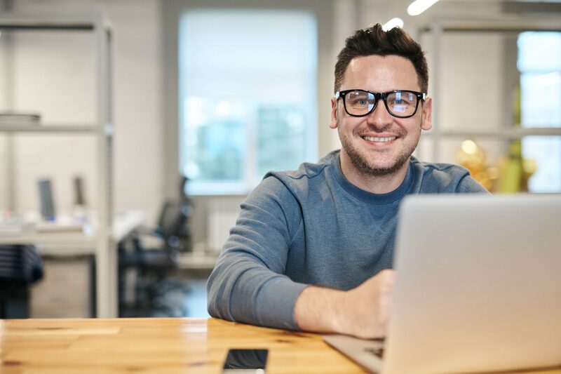 Team member working at a bright open-plan office desk