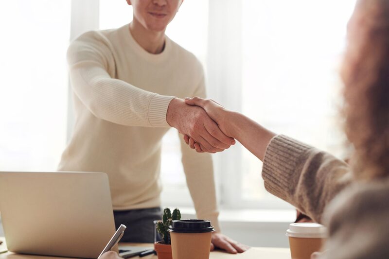 Sales representative shaking hands with a customer after a face-to-face consultation