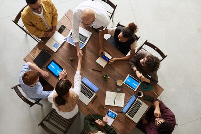 Overhead view of a team reviewing market research together